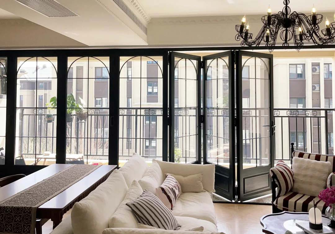 A multi-panel aluminum bi-fold door wall opening onto a patio.